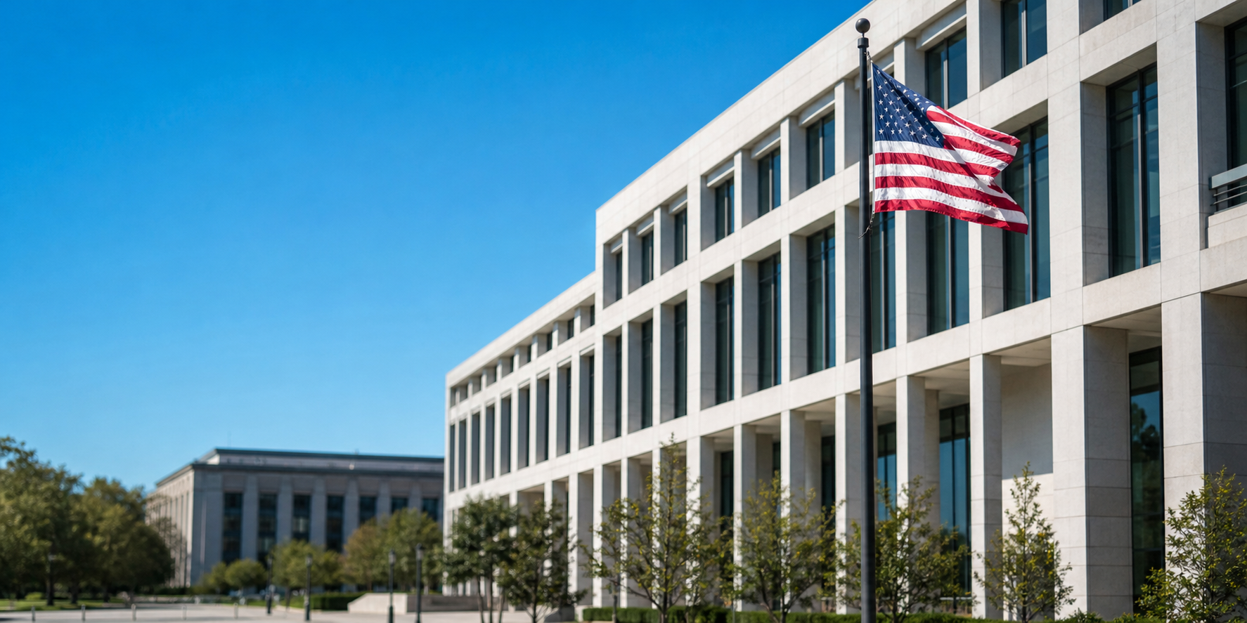 Modern federal government office building exterior with American flag under clear blue sky